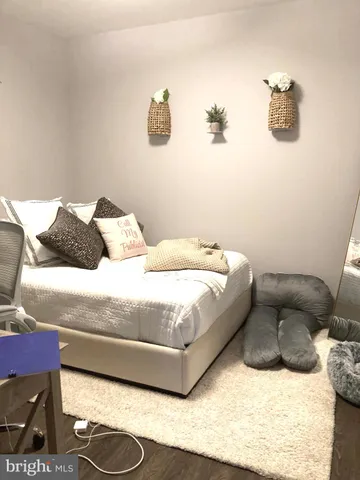 a bedroom with a bed and wall painting