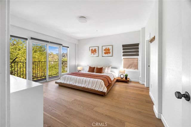 a spacious bedroom with a bed and a large window