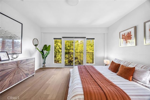 a bedroom with a bed and a large window