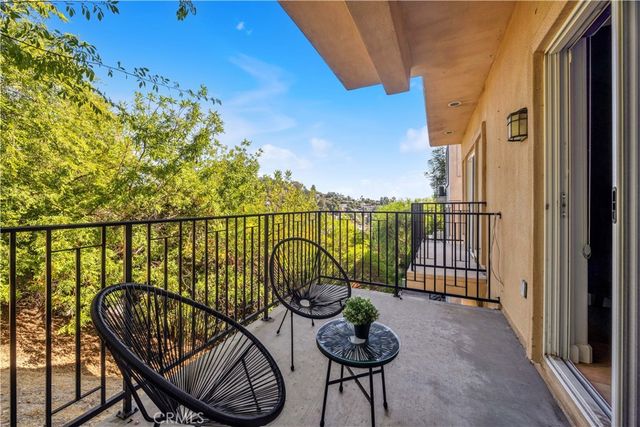 a view of a balcony with chairs