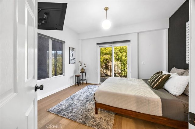 a bedroom with a bed a mirror and a window