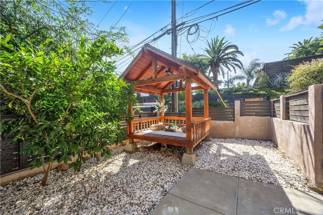 a view of a house with a yard siting area and garden