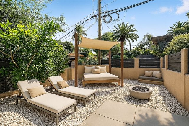 a view of a patio with couches and potted plants