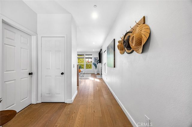 a view of entryway and hall with wooden floor