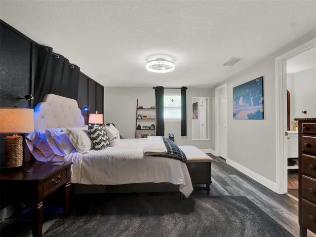 a spacious bedroom with a bed and couch