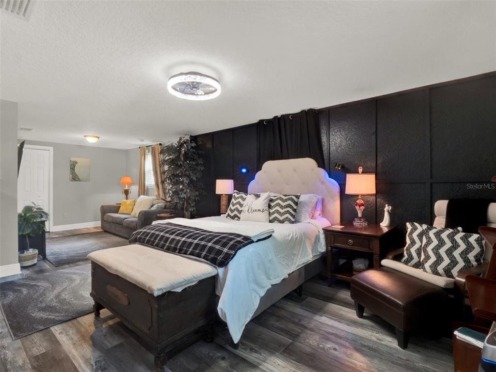 2721 Evergreen Drive Edgewater, FL 32141 - Photo 18 of 29 a spacious bedroom with a bed and couch
