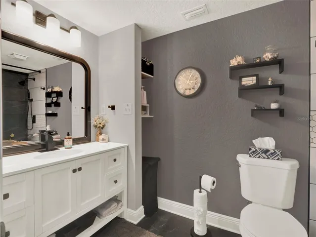 a white toilet sitting next to a bathroom sink