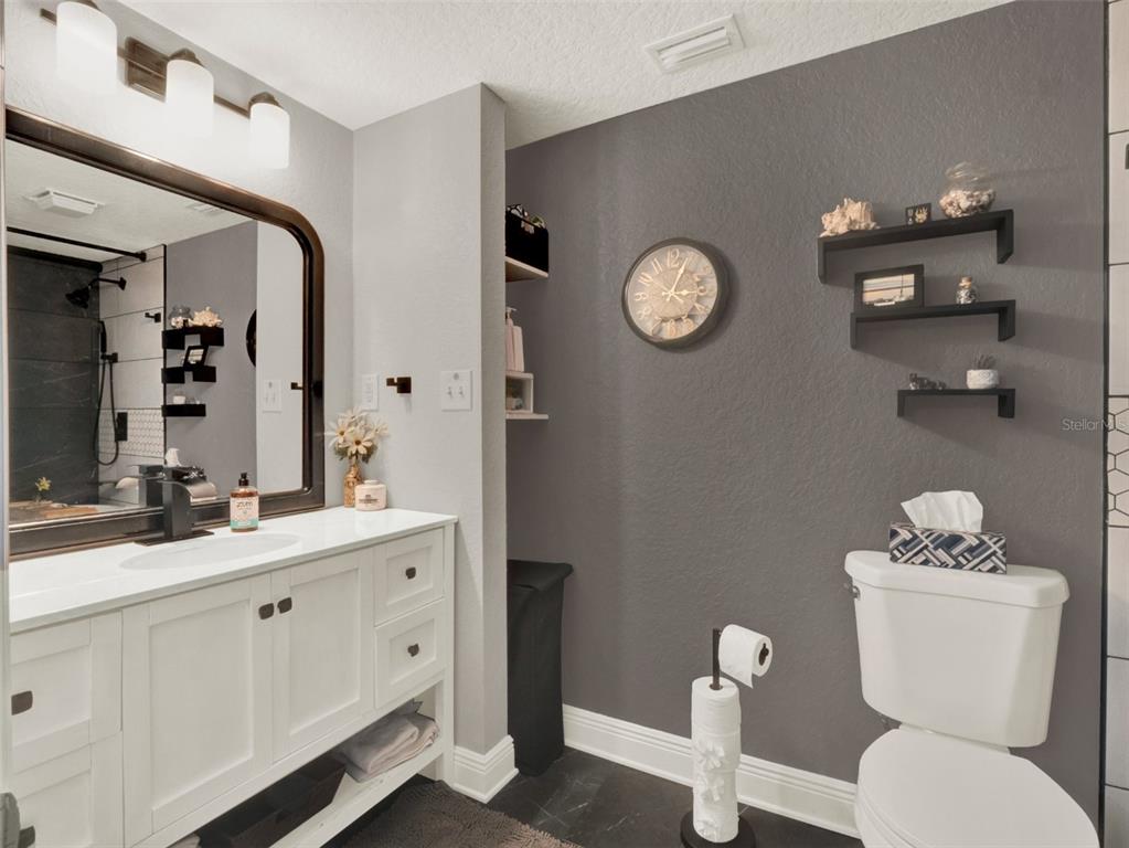 2721 Evergreen Drive Edgewater, FL 32141 - Photo 20 of 29 a bathroom with a toilet a sink and mirror