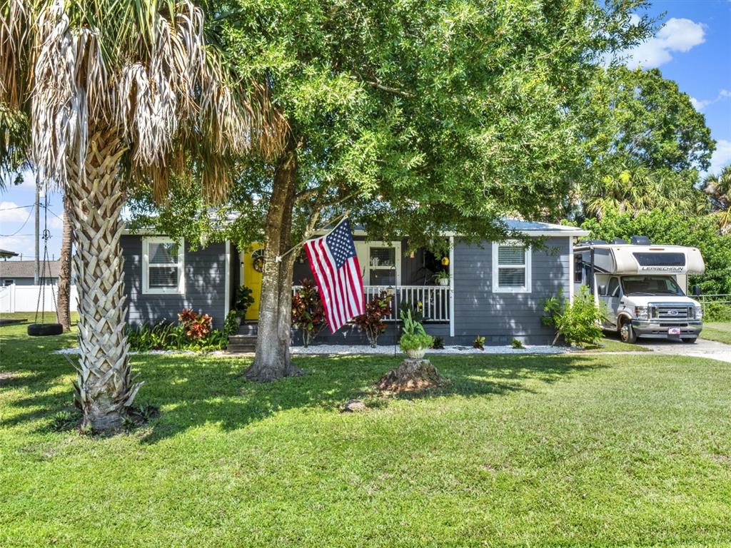 2721 Evergreen Drive Edgewater, FL 32141 - Photo 2 of 29 a front view of a house with a yard and trees