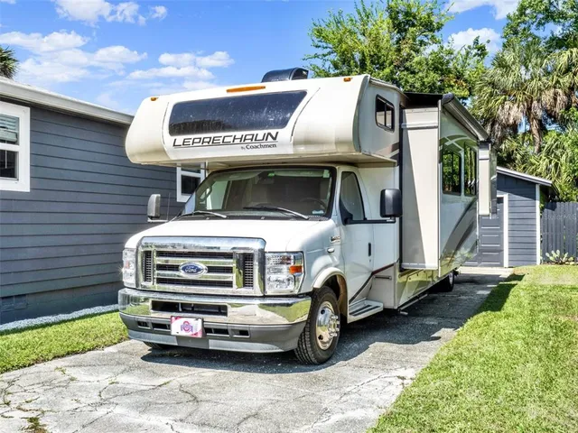 a car parked in front of a house with a big yard