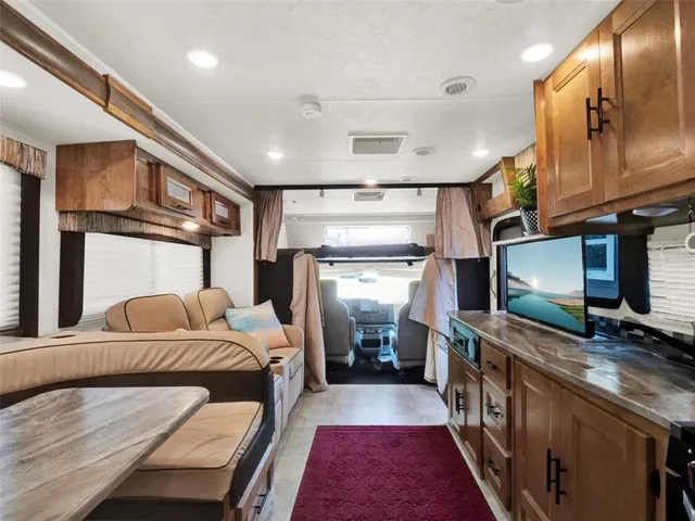 a bedroom with a large bed and a large mirror