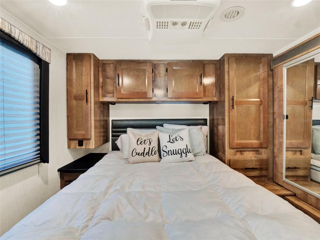 2721 Evergreen Drive Edgewater, FL 32141 - Photo 29 of 29 a bedroom with a large bed and a large mirror