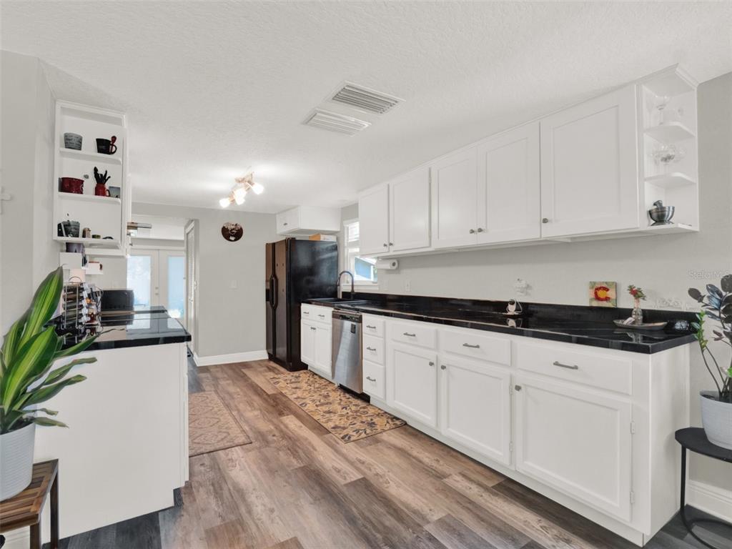 2721 Evergreen Drive Edgewater, FL 32141 - Photo 7 of 29 a kitchen with granite countertop a sink a stove and cabinets