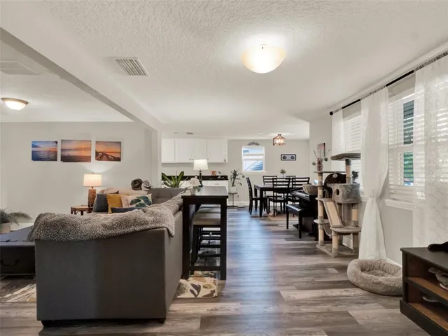 a living room with furniture and kitchen view