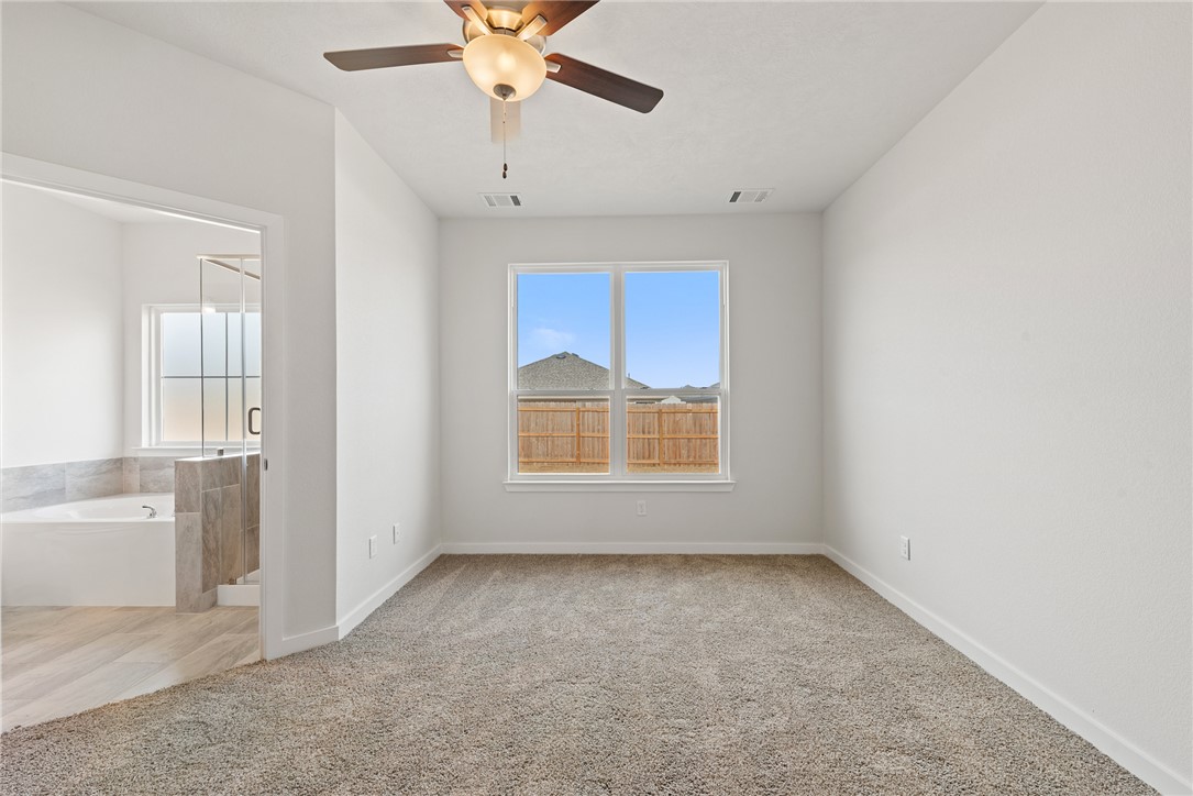2412 Rooke Road Bryan, TX 77807 - Photo 21 of 35 an empty room with windows and fan