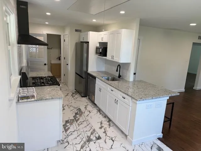 a kitchen with stainless steel appliances granite countertop a stove and a refrigerator