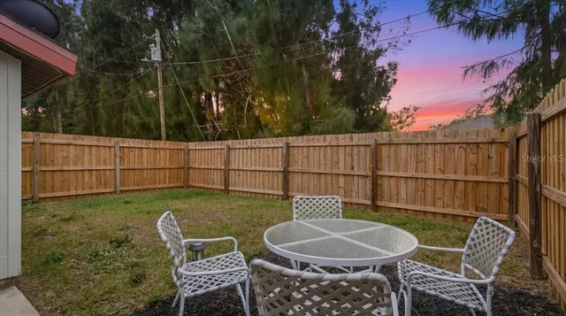 a view of a chairs and table in the patio