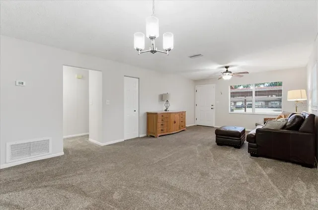 a living room with furniture and a chandelier