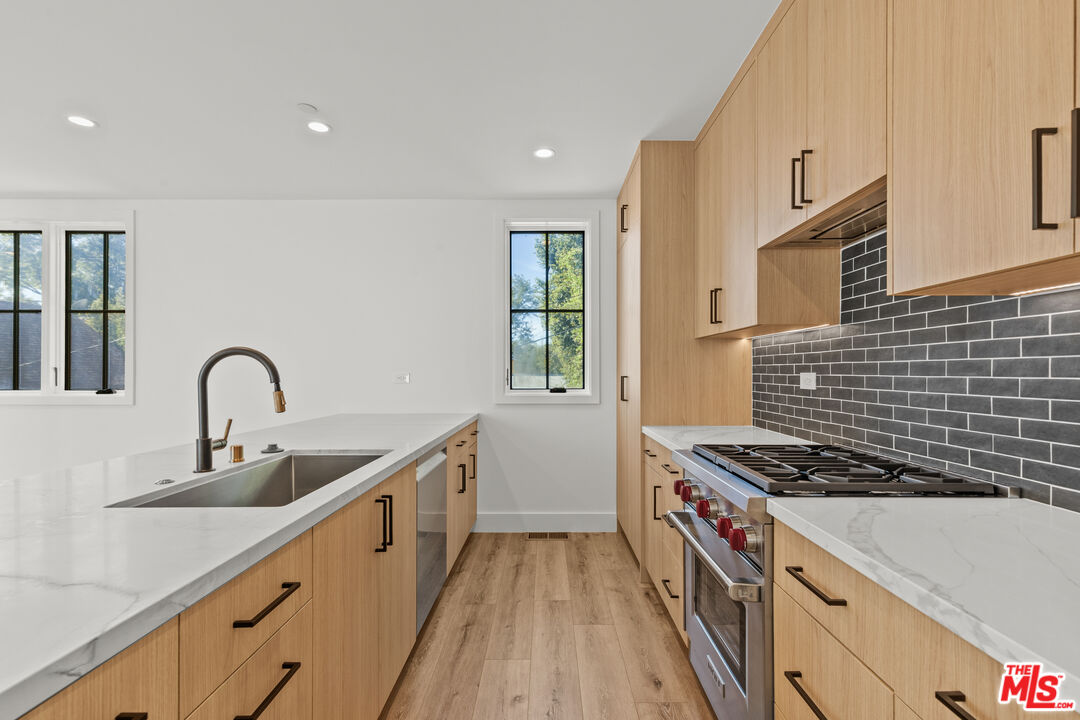 5539 Tova Road Sherman Oaks, CA 91411 - Photo 3 of 17 a kitchen with sink a stove and cabinets