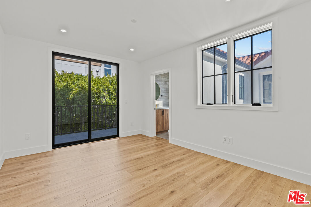 5539 Tova Road Sherman Oaks, CA 91411 - Photo 7 of 17 a view of an empty room with wooden floor and a window