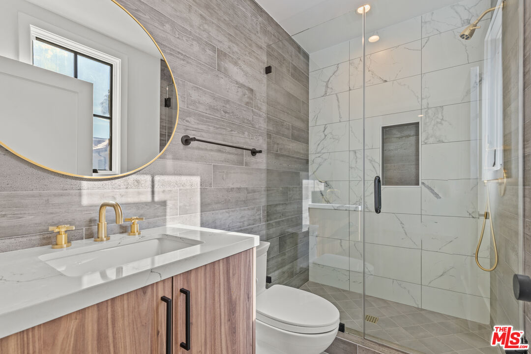5539 Tova Road Sherman Oaks, CA 91411 - Photo 8 of 17 a bathroom with a sink a toilet and shower
