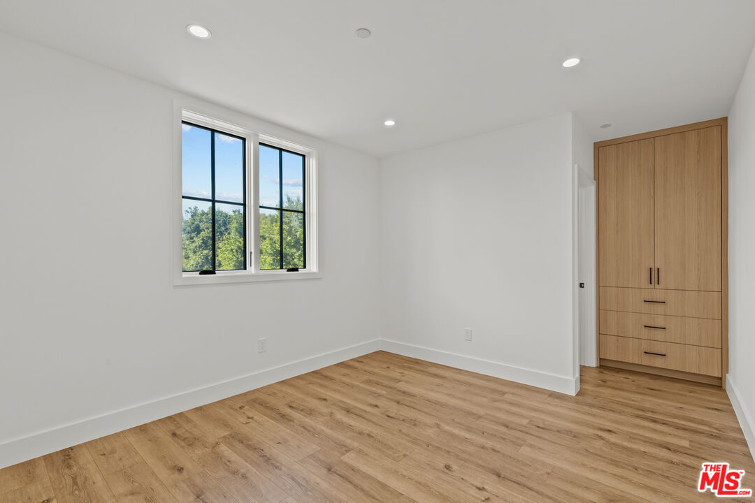5539 Tova Road Sherman Oaks, CA 91411 - Photo 9 of 17 wooden floor in an empty room with a window