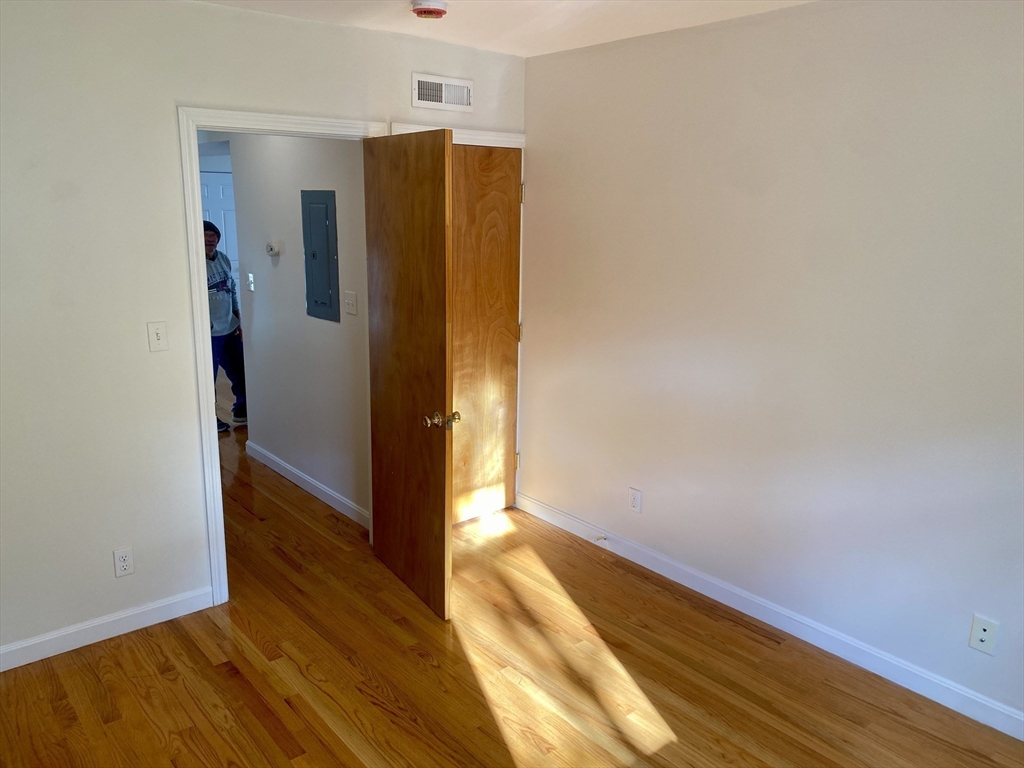 123 Thorndike Street, Unit 2L Cambridge, MA 02141 - Photo 13 of 19 a view of hallway with wooden floor