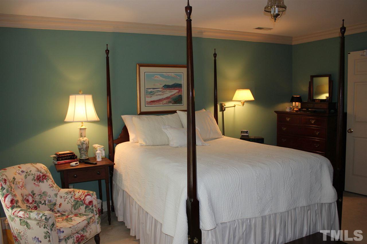 3308 Churchill Road Raleigh, NC 27607 - Photo 15 of 25 a bedroom with a bed and a lamp on dresser