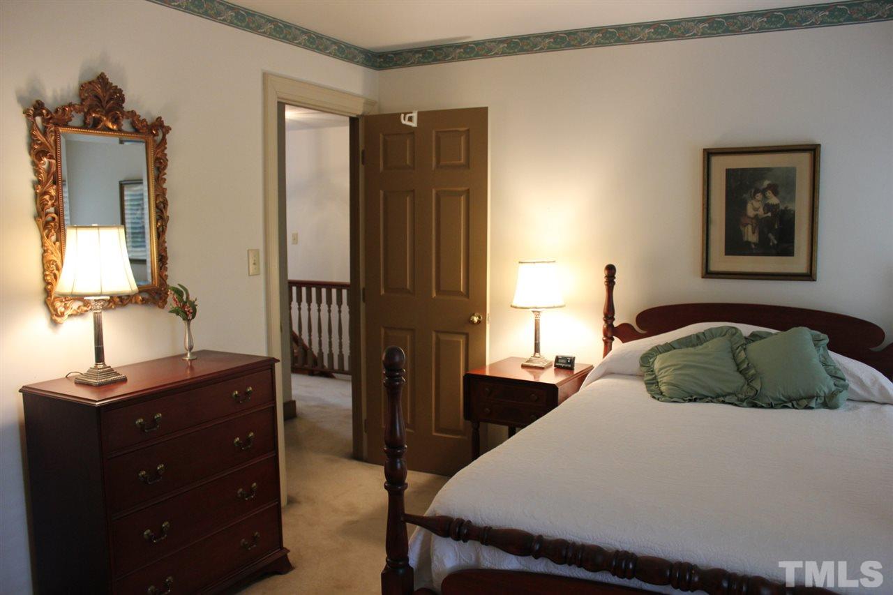 3308 Churchill Road Raleigh, NC 27607 - Photo 17 of 25 a bedroom with a bed and a table