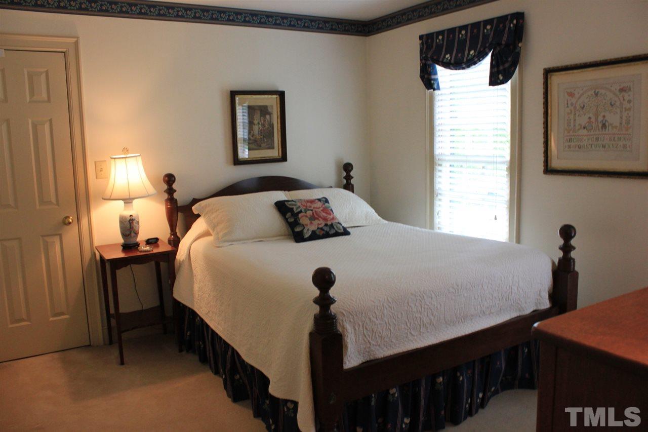 3308 Churchill Road Raleigh, NC 27607 - Photo 19 of 25 a bedroom with a bed and a window