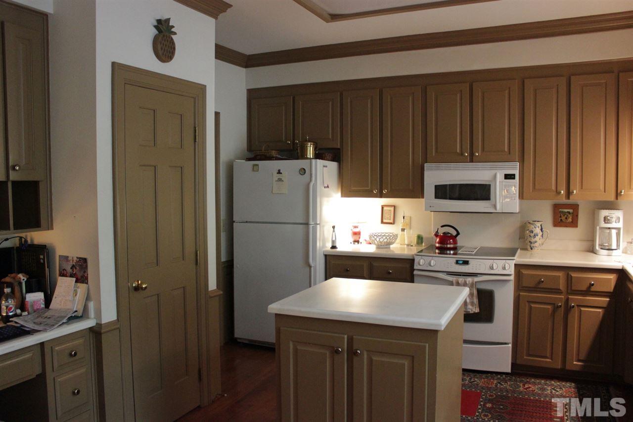 3308 Churchill Road Raleigh, NC 27607 - Photo 9 of 25 a kitchen with sink a refrigerator and cabinets