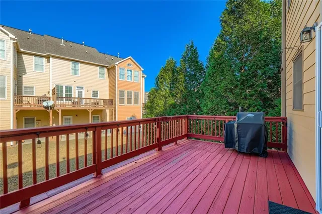a view of balcony with wooden floor and fence