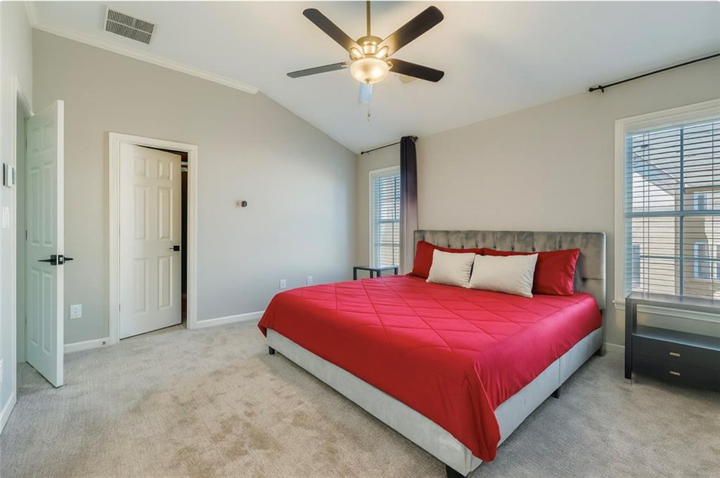 6414 Queens Court Trace, Unit 7 Mableton, GA 30126 - Photo 16 of 28 a bedroom with a bed and a chandelier