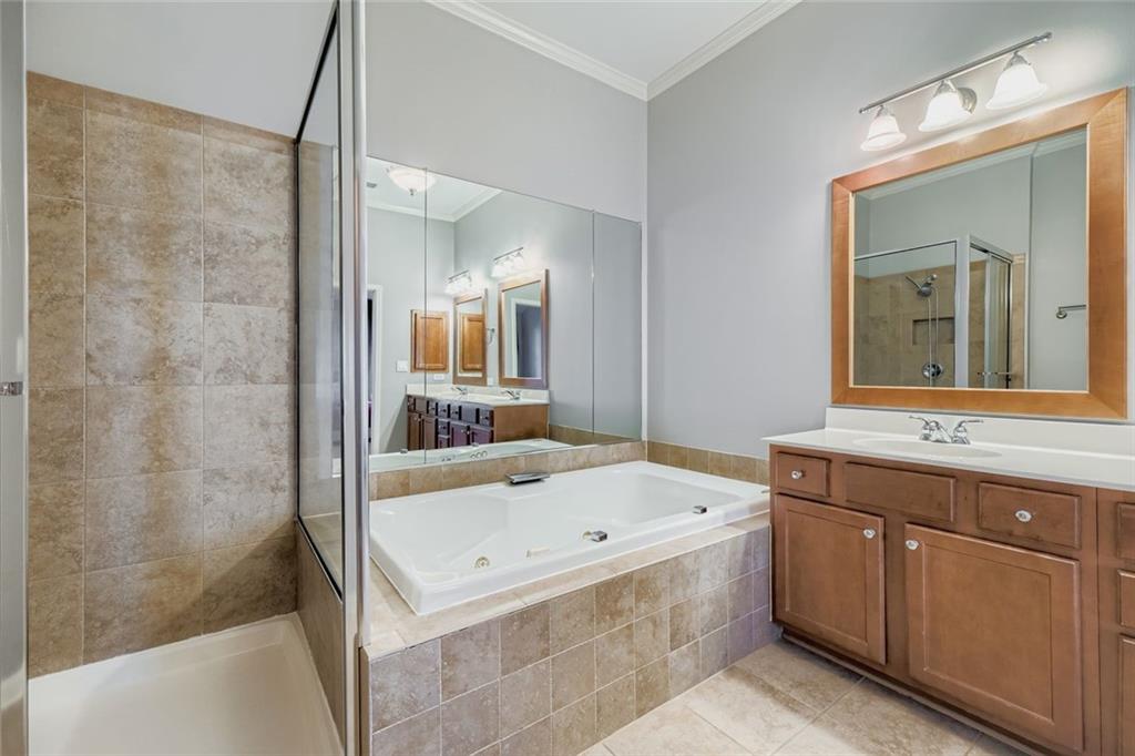 6414 Queens Court Trace, Unit 7 Mableton, GA 30126 - Photo 18 of 28 a bathroom with a tub a sink and mirror