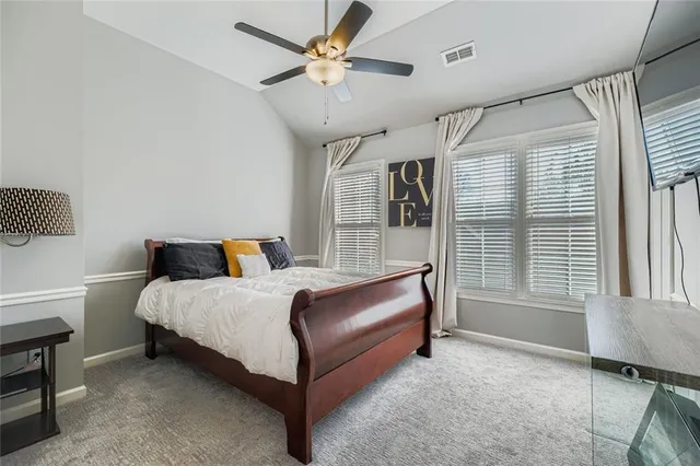 a bedroom with a bed dresser and a window