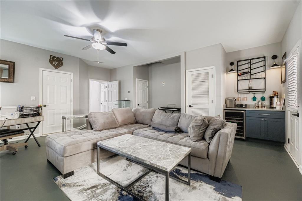 6414 Queens Court Trace, Unit 7 Mableton, GA 30126 - Photo 23 of 28 a living room with furniture and a chandelier