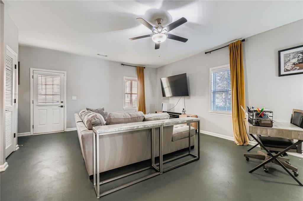 6414 Queens Court Trace, Unit 7 Mableton, GA 30126 - Photo 24 of 28 a living room with a couch and a flat screen tv