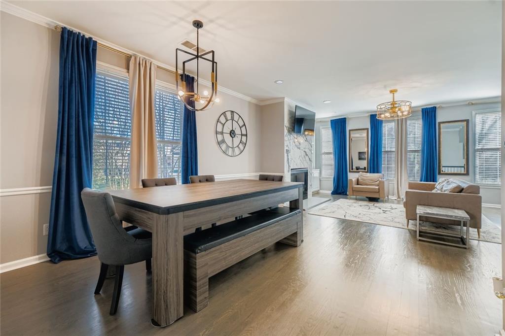 6414 Queens Court Trace, Unit 7 Mableton, GA 30126 - Photo 10 of 28 a living room with furniture a large window and wooden floor