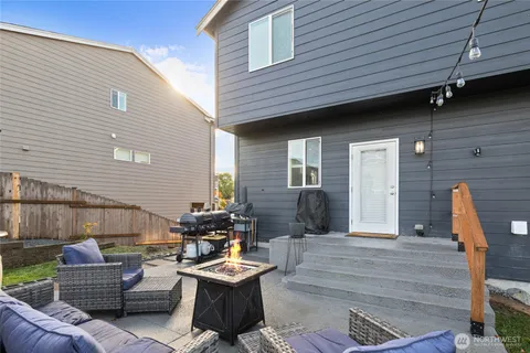 a view of a house with a yard and sitting area