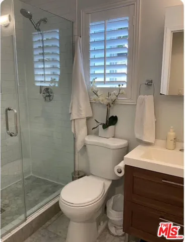 a bathroom with a toilet sink and shower