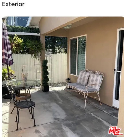 a view of a patio with a table and chairs