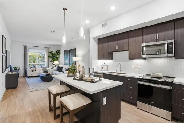 a kitchen with a sink stove and microwave
