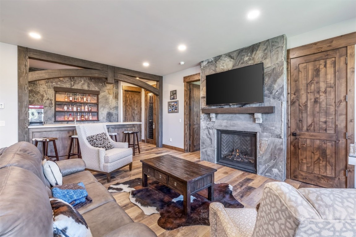 242 Point View Place Breckenridge, CO 80424 - Photo 24 of 47 a living room with furniture a flat screen tv and a fireplace