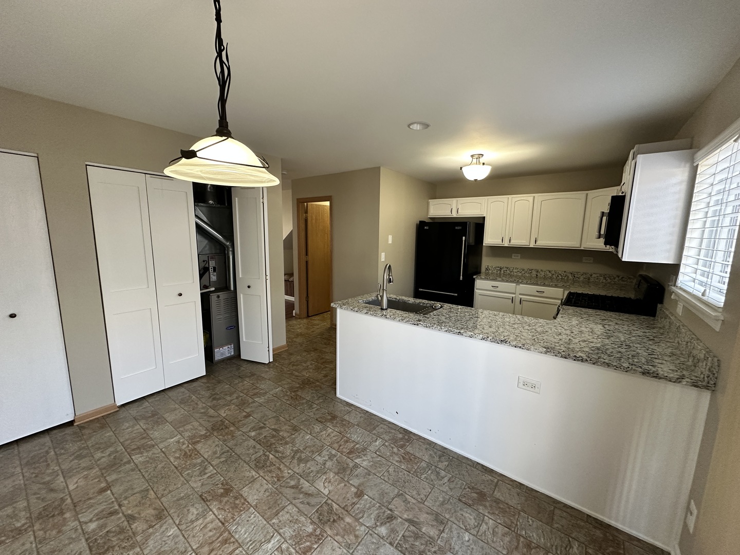 896 Emerald Drive Pingree Grove, IL 60140 - Photo 8 of 19 a view of a kitchen with a sink and a refrigerator