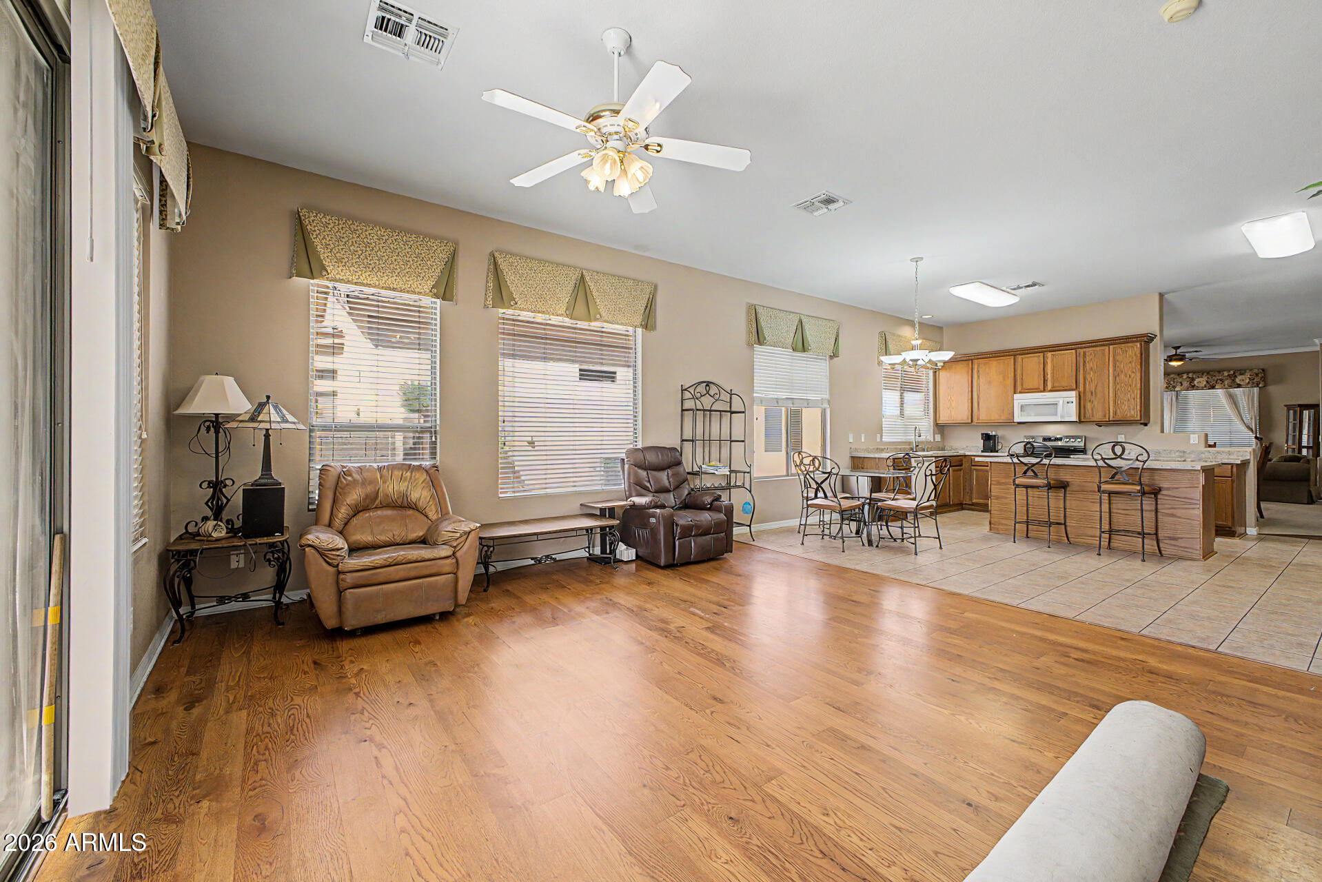 4394 South Strong Box Road Gold Canyon, AZ 85118 - Photo 11 of 33 a living room with furniture and a chandelier