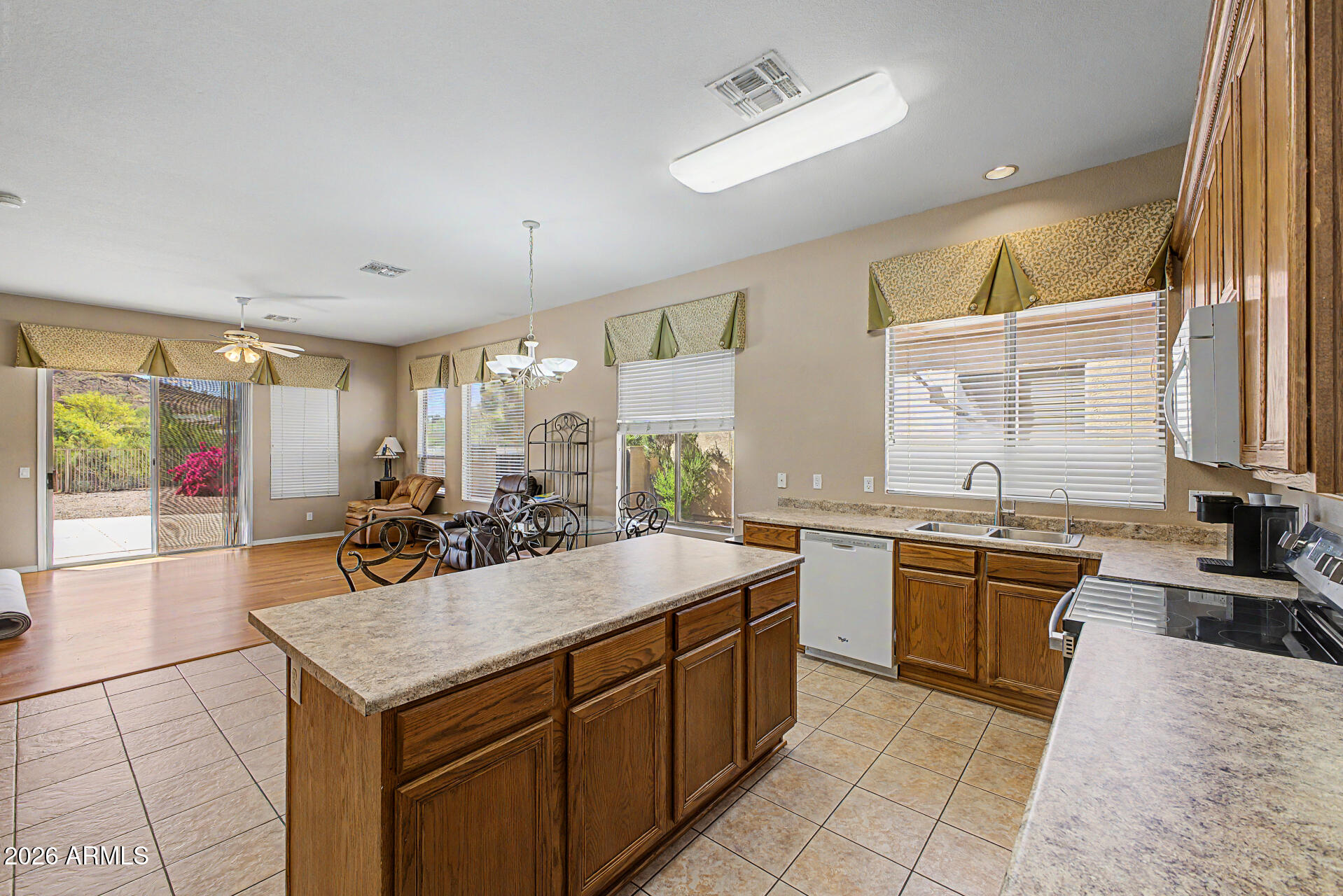 4394 South Strong Box Road Gold Canyon, AZ 85118 - Photo 14 of 33 a kitchen with sink stove and cabinets