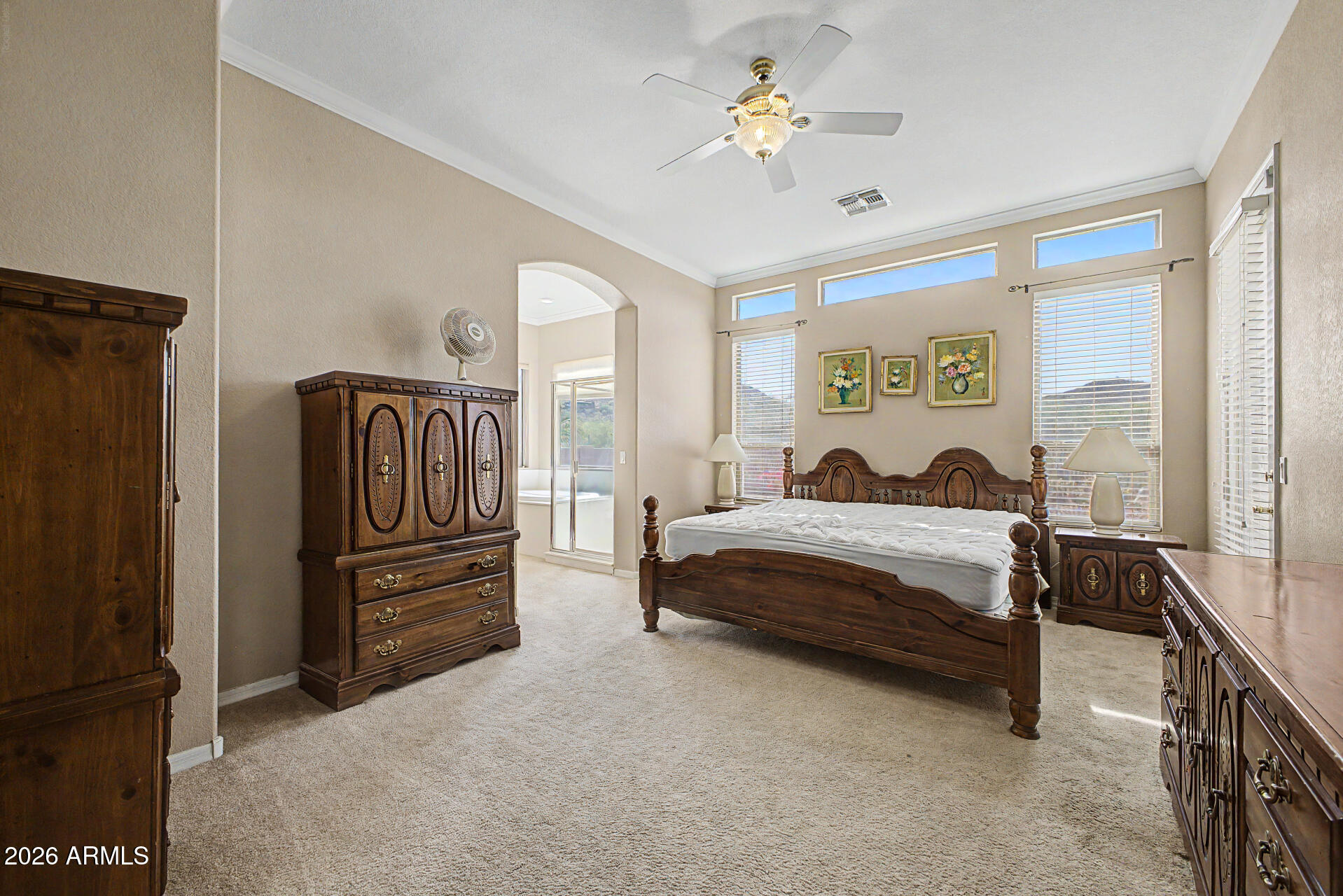 4394 South Strong Box Road Gold Canyon, AZ 85118 - Photo 16 of 33 a spacious bedroom with a bed dresser and a window