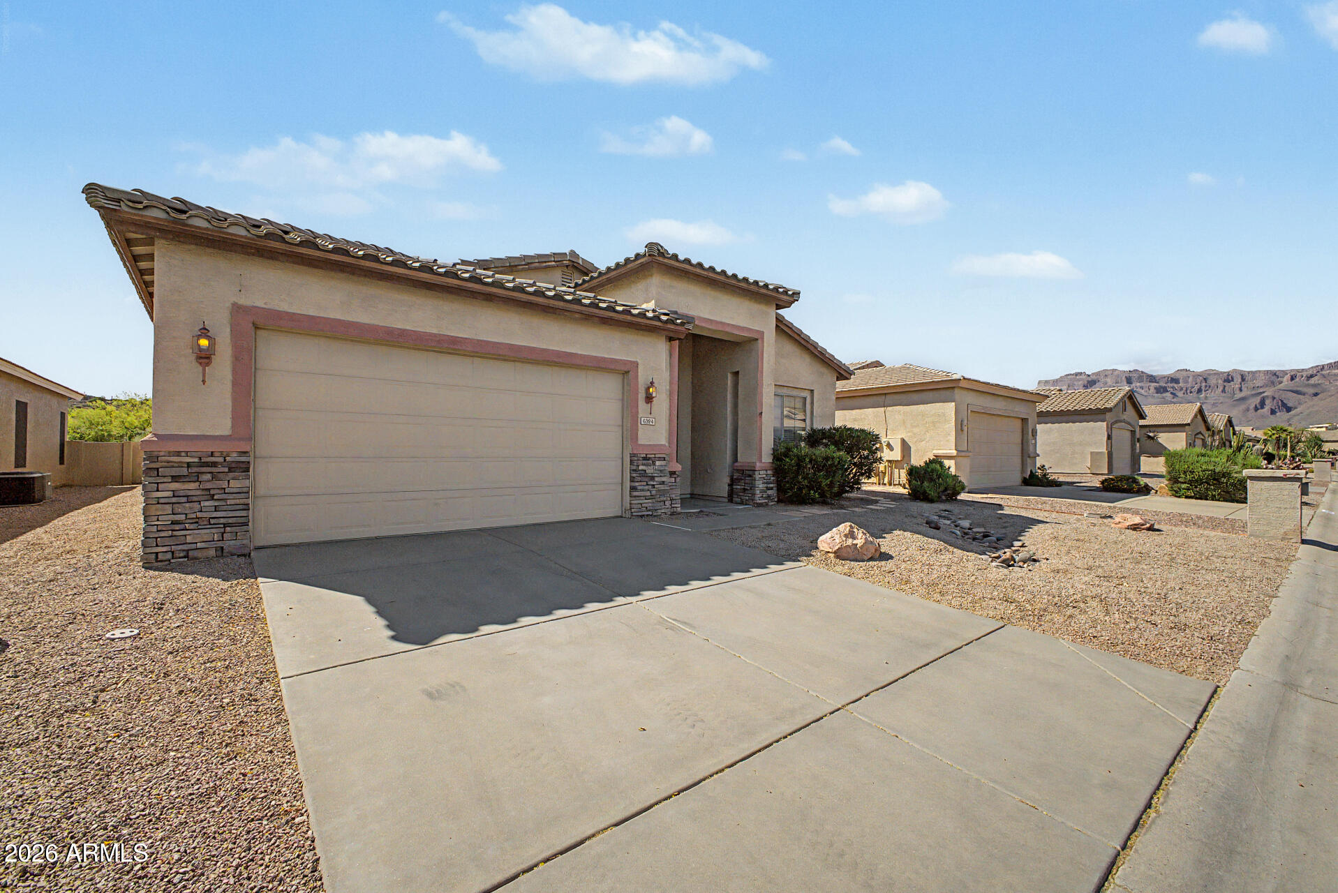 4394 South Strong Box Road Gold Canyon, AZ 85118 - Photo 2 of 33 a front view of a house with a yard and garage