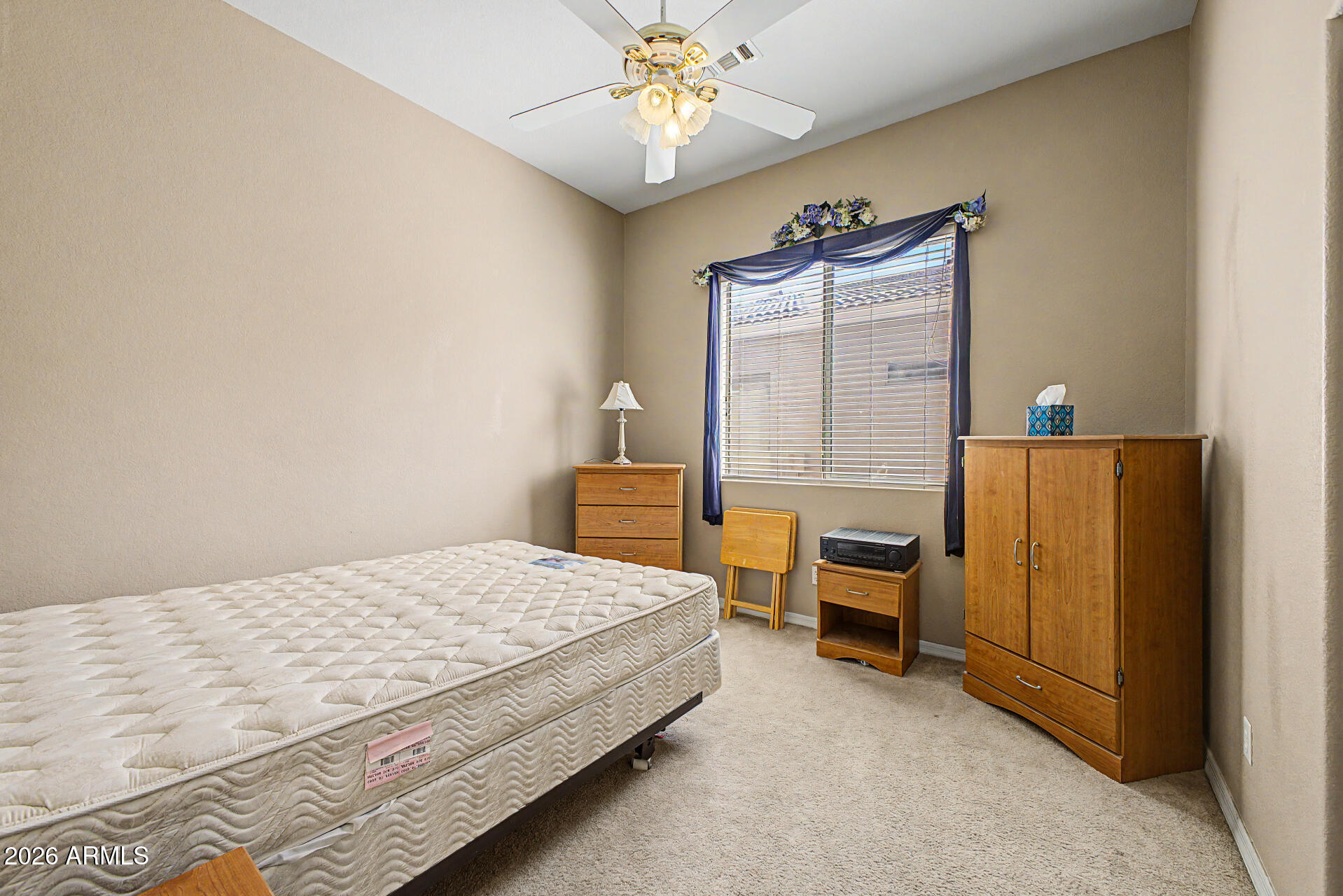 4394 South Strong Box Road Gold Canyon, AZ 85118 - Photo 21 of 33 a bedroom with a bed and a chandelier