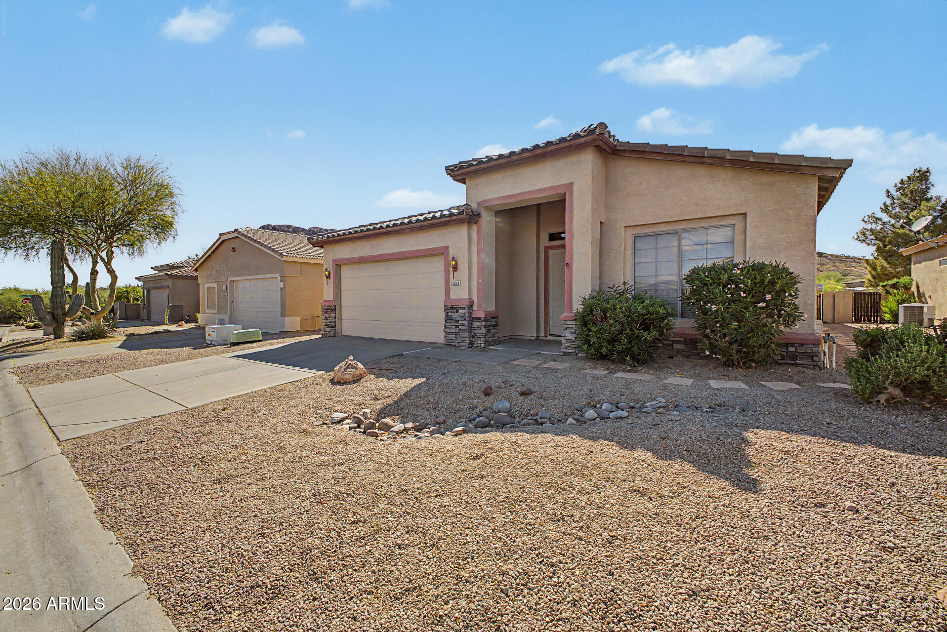4394 South Strong Box Road Gold Canyon, AZ 85118 - Photo 3 of 33 a front view of a house with a yard and garage
